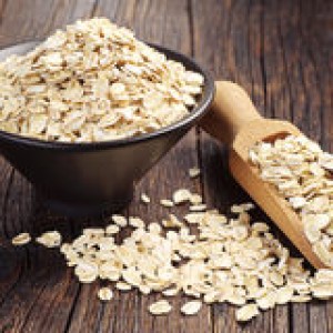 oatmeal-bowl-scoop-oat-flakes-dark-wooden-table-46828530