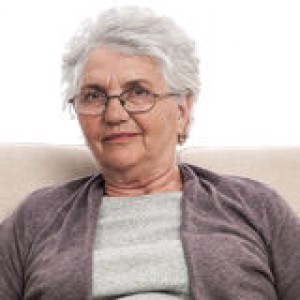 senior-portrait-disappointed-person-woman-sitting-sofa-grey-hair-glasses-casual-dress-old-34570855